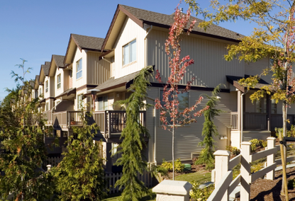 row of townhomes and some green trees